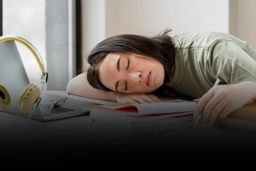 Woman experiencing persistent daytime sleepiness while studying